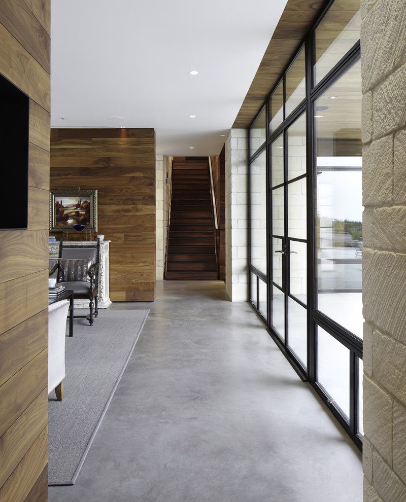 Acid Stained Concrete for a Contemporary Hall with a Dark Wood Staircase and Hill Country Residence by Cornerstone Architects