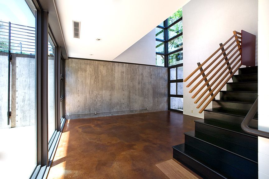 Acid Stained Concrete for a Modern Staircase with a Living Room and Newning House Living by Tom Hurt Architecture