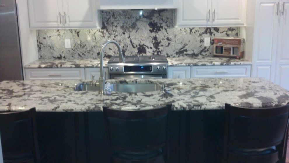 Alaskan White Granite for a Traditional Kitchen with a Island and Kitchen Counter and Back Splash by Abruzzi Stone & Flooring