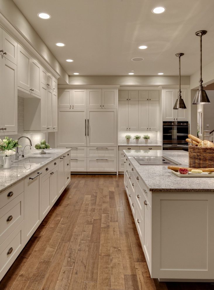 Alaskan White Granite for a Transitional Kitchen with a Wood Floor and Woodinville Retreat by Studio 212 Interiors