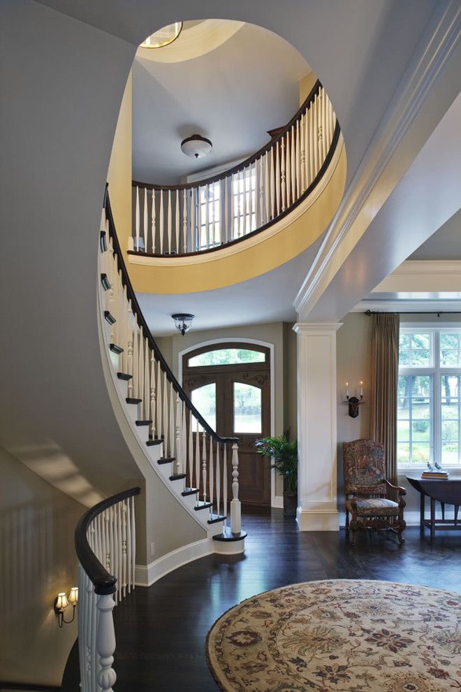 Ambella Home for a Traditional Staircase with a White Stair Railing and Curved Stairway and Front Door by Erotas Building Corporation