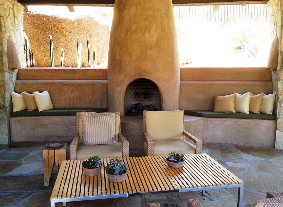 American Rattan for a Southwestern Patio with a Built in Window Seat and Estancia Club  Fireplace by Merit Landworks