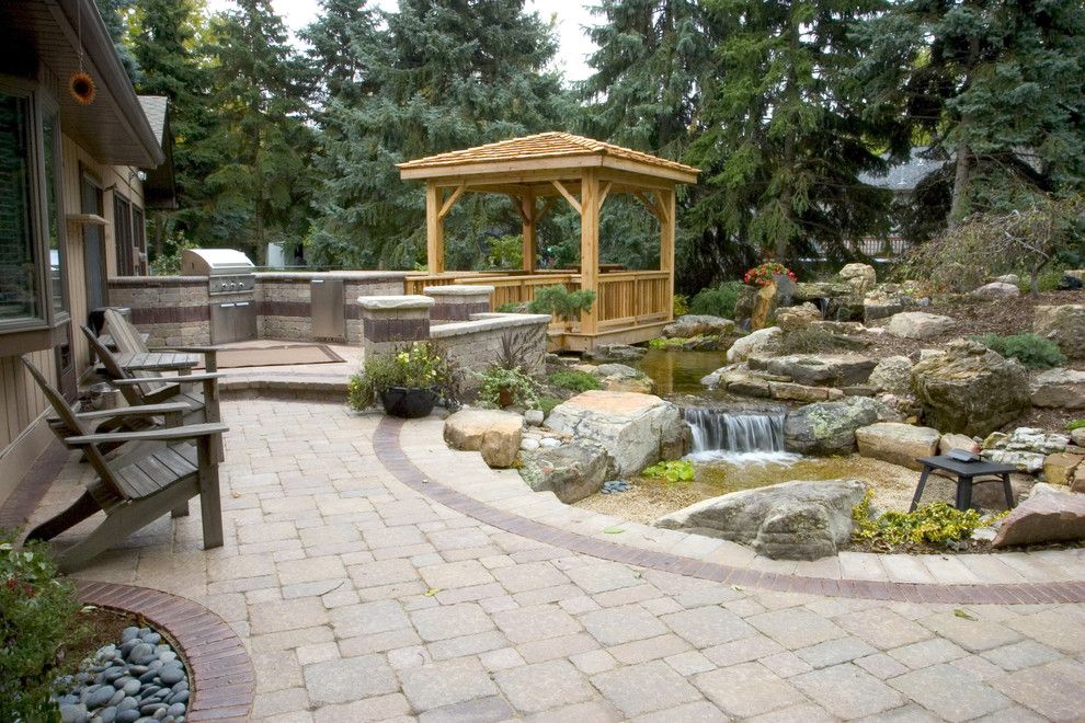 Aquascape for a Traditional Landscape with a Boulder and Outdoor Living with Water Gardens by Aquascape Inc.