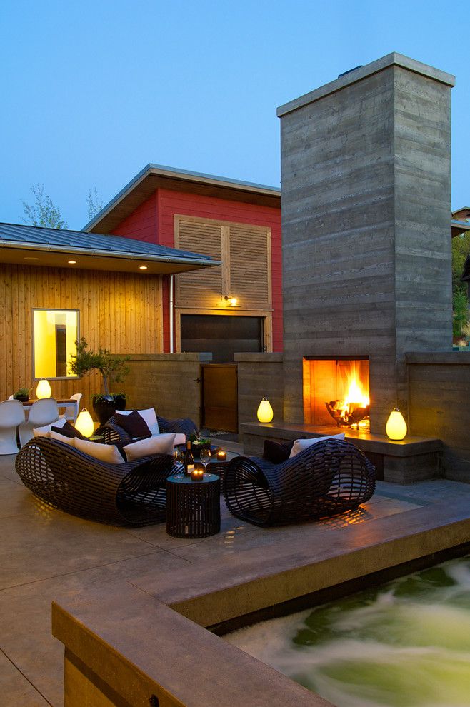 Asphalt vs Concrete for a Contemporary Patio with a Concrete Fireplace and Modern Patio by Rcodesigners.com