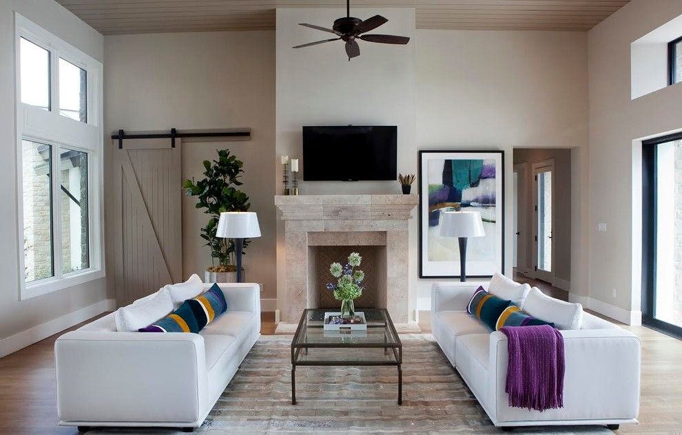 Austin Hardwoods for a Contemporary Family Room with a Barn Door and Barton Creek One by Kim Ledlie Design