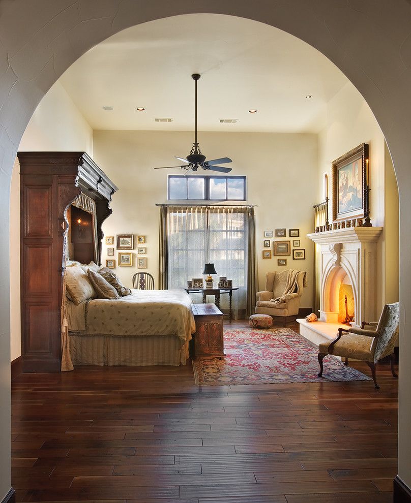 Austin Hardwoods for a Mediterranean Bedroom with a Dark Floor and Lake Home Master Bedroom by Cornerstone Architects