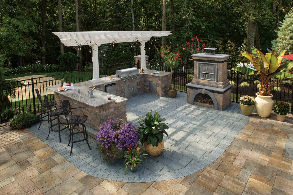 Backyard Makeover for a Contemporary Spaces with a Outdoor Fireplace and Cambridge Pavingstones with Armortec by Cambridge Pavingstones with Armortec