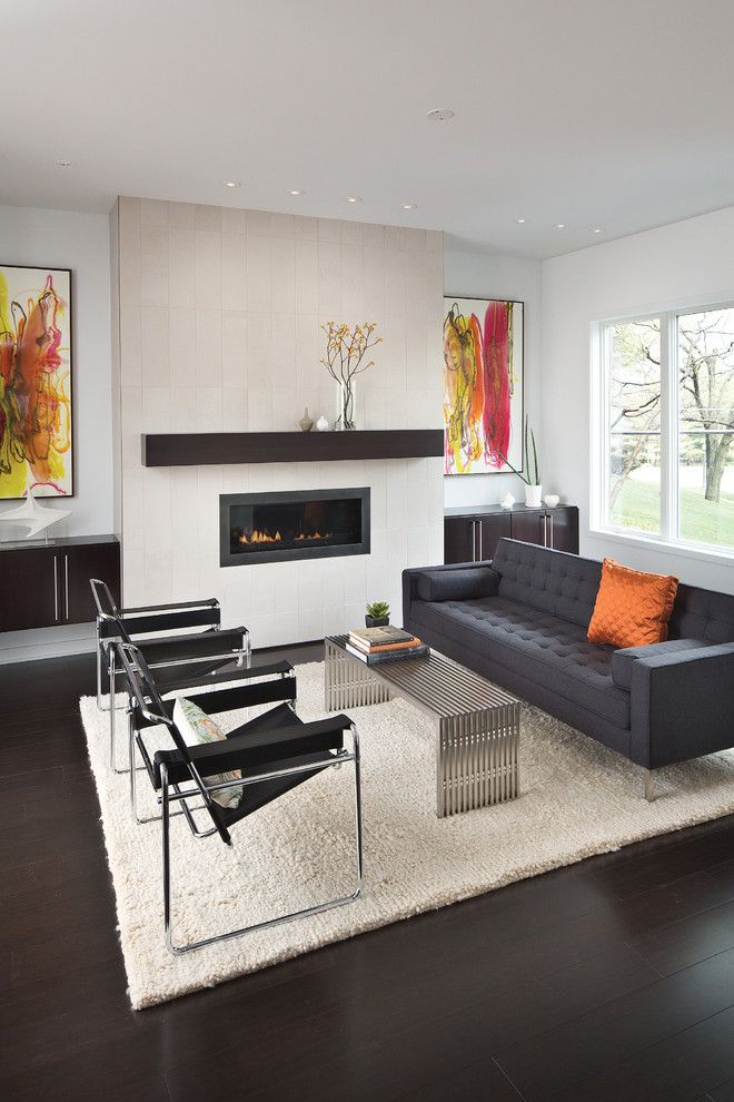 Bamboo vs Hardwood for a Contemporary Living Room with a Custom Fireplace and Modern White Counters by Adam Gibson Design