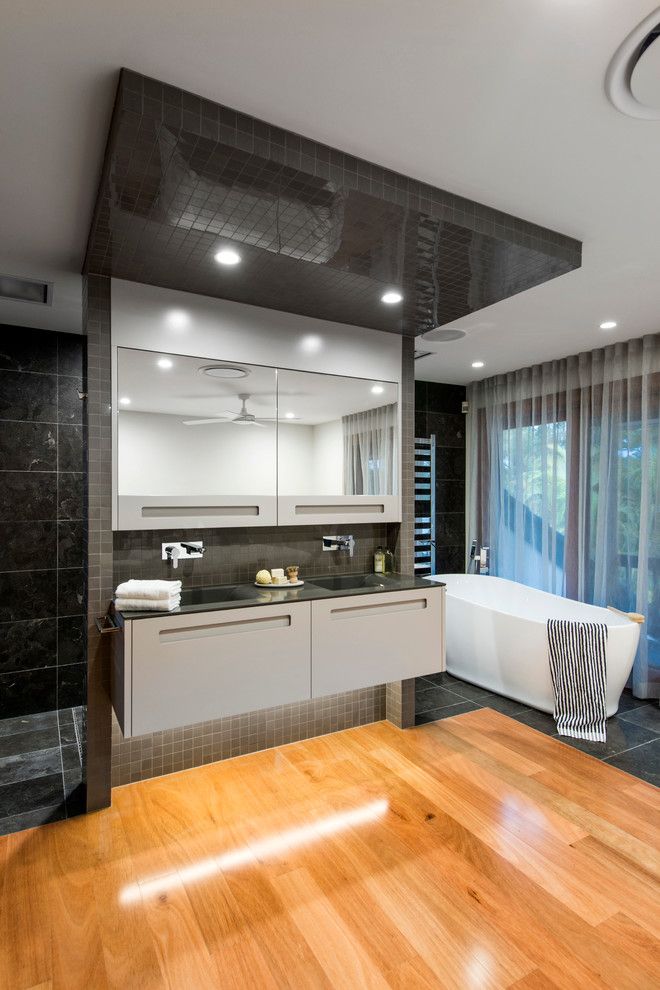 Bathroom Layouts for a Contemporary Bathroom with a Black Countertop and Contemporary Queensland Bathroom Design by Darren James Interiors