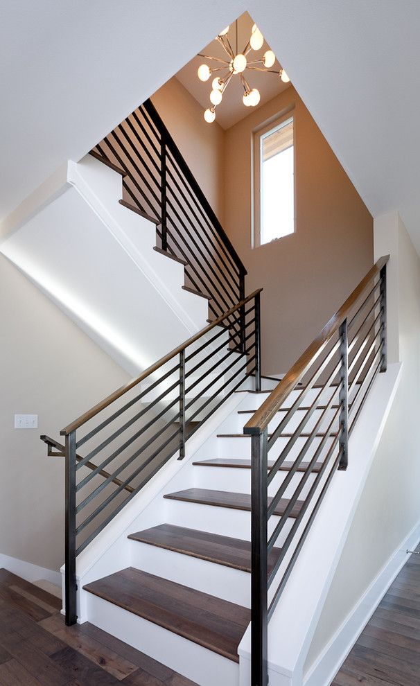 Blackened Steel for a Contemporary Staircase with a Dark Floor and Dyna   Mt Baker2 by Dyna Contracting