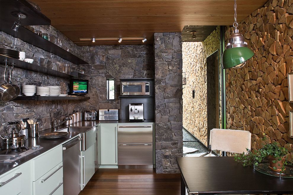 Blackened Steel for a Rustic Kitchen with a Barn and Stone Creek Camp by Andersson Wise Architects