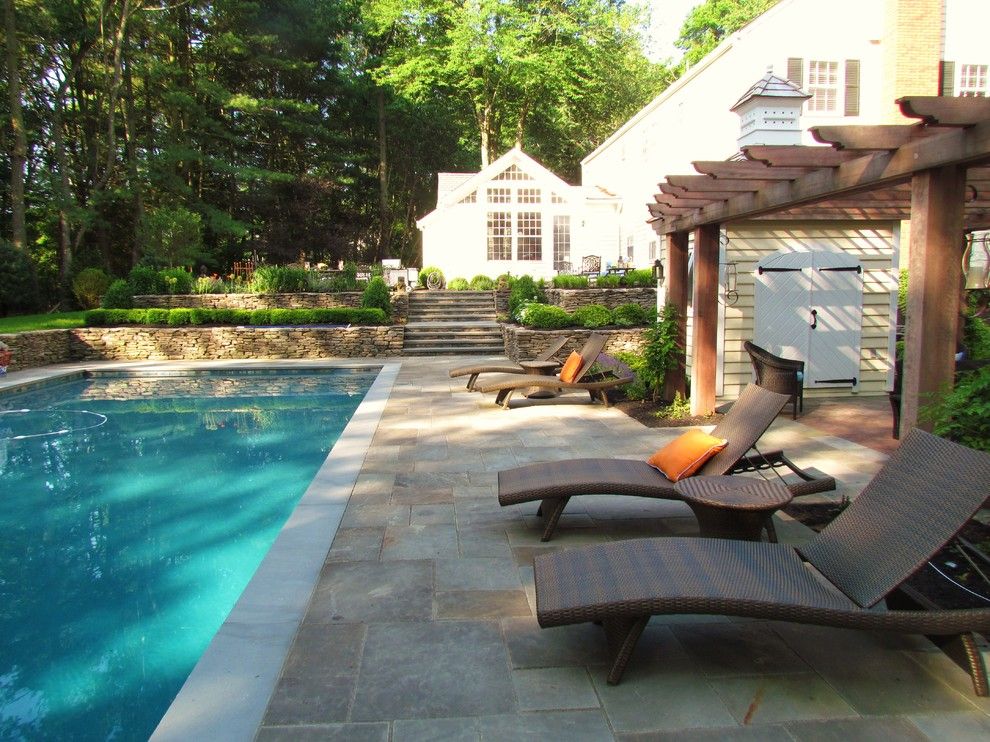 Blue Hawaiian Pools for a Traditional Landscape with a Wood Pergola and Timeless Elegance by Harmony Design Group