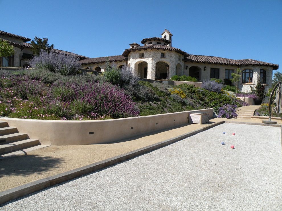 Bocce Ball Court for a Mediterranean Landscape with a Hillside Planting and Carmel Valley 01 (Design by Ron Herman) by Frank & Grossman Landscape Contractors, Inc.