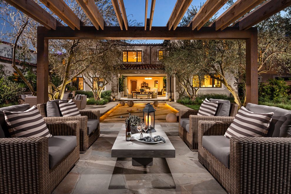 Bocce Ball Court for a Mediterranean Patio with a Striped Cushions and Trevi by Robert Hidey Architects