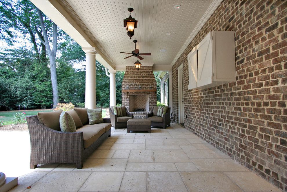 Brick Paver Patterns for a Traditional Porch with a Brick Fireplace Surround and Rear Porch by Dresser Homes