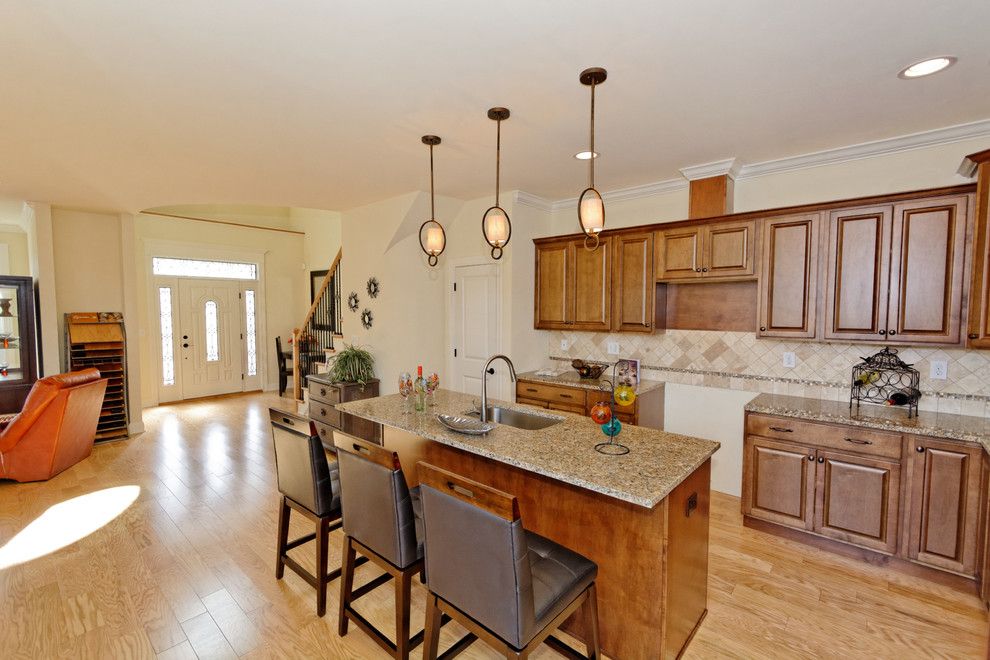 Capitol Granite for a Traditional Kitchen with a Custom Kitchen Cabinets and Village at Shaker Creek by Viscusi Builders Ltd.