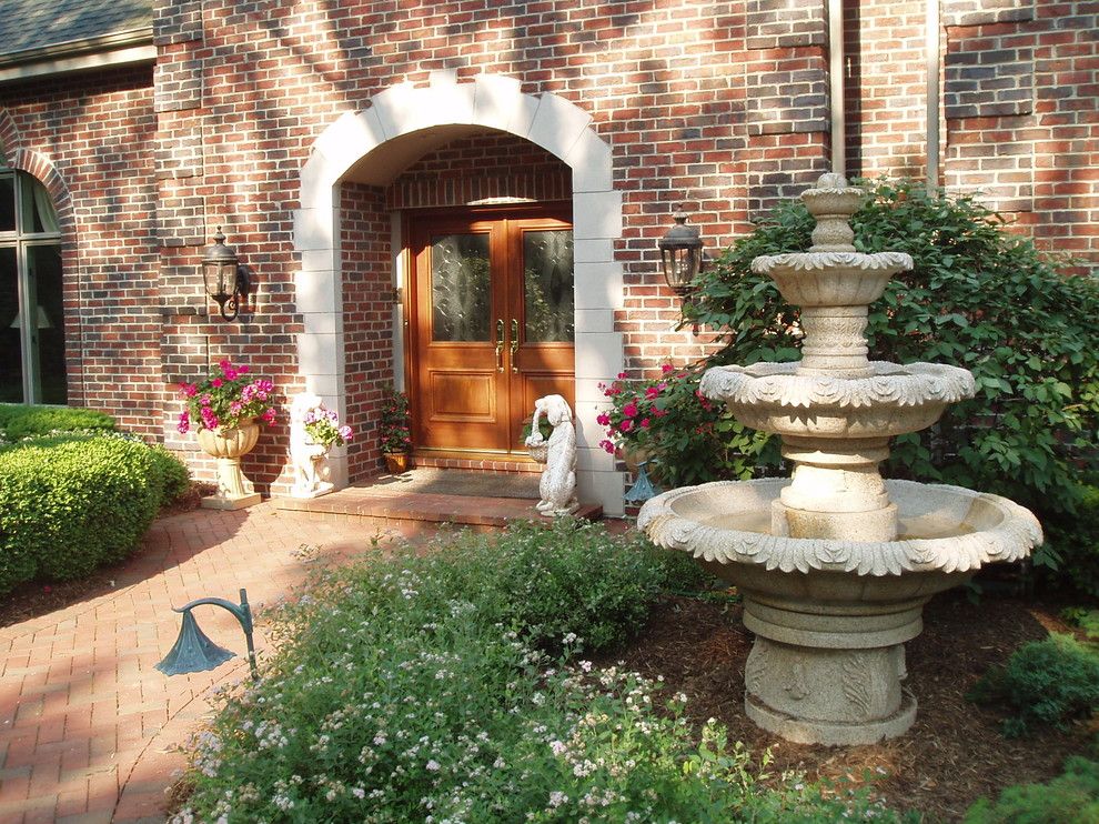 Carved Creations for a Traditional Landscape with a Brick Exterior and Granite Garden Fountain by Carved Stone Creations, Inc.