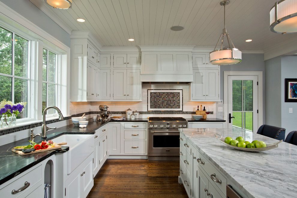 Chelsea Plank Flooring for a Farmhouse Kitchen with a Mantle and Farmhouse Vernacular by Teakwood Builders, Inc.