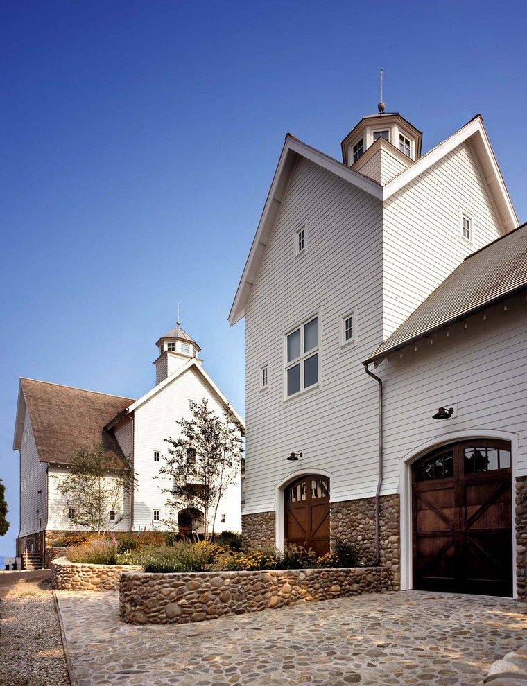 Cobblestone Wall for a Beach Style Exterior with a Exterior Carriage Doors and House on Belle Island by Beinfield Architecture Pc