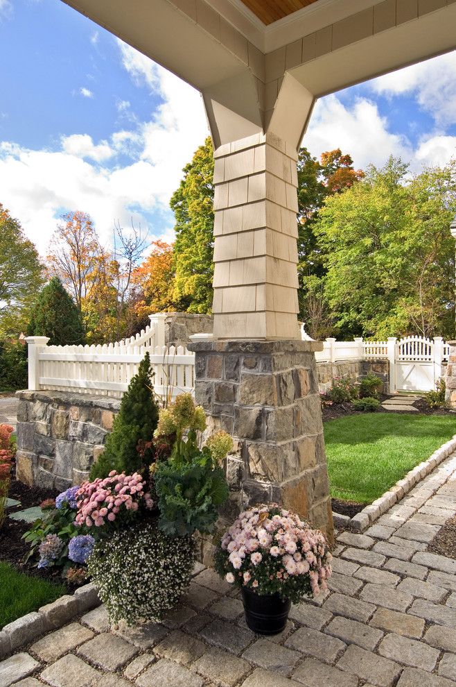 Cobblestone Wall for a Traditional Landscape with a Container Plant and 2009 Showcase Home on Park Alley by Witt Construction