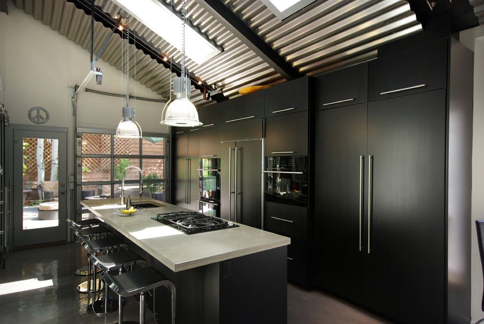 Concrete Countertop Solutions for a Industrial Kitchen with a Black Kitchen and Contemporary Black Kitchen with Concrete Counters and Stainless Steel Fixtures by Renovation Design Group