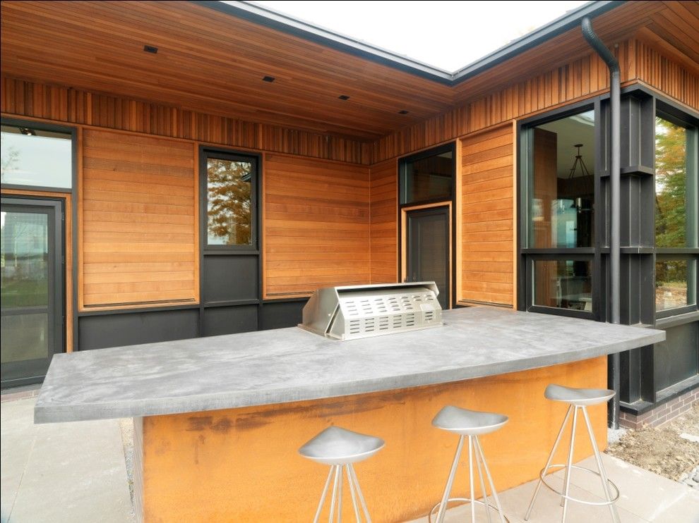 Concrete Countertop Solutions for a Rustic Patio with a Concrete Paving and Quaker Bluff Residence by Birdseye Design