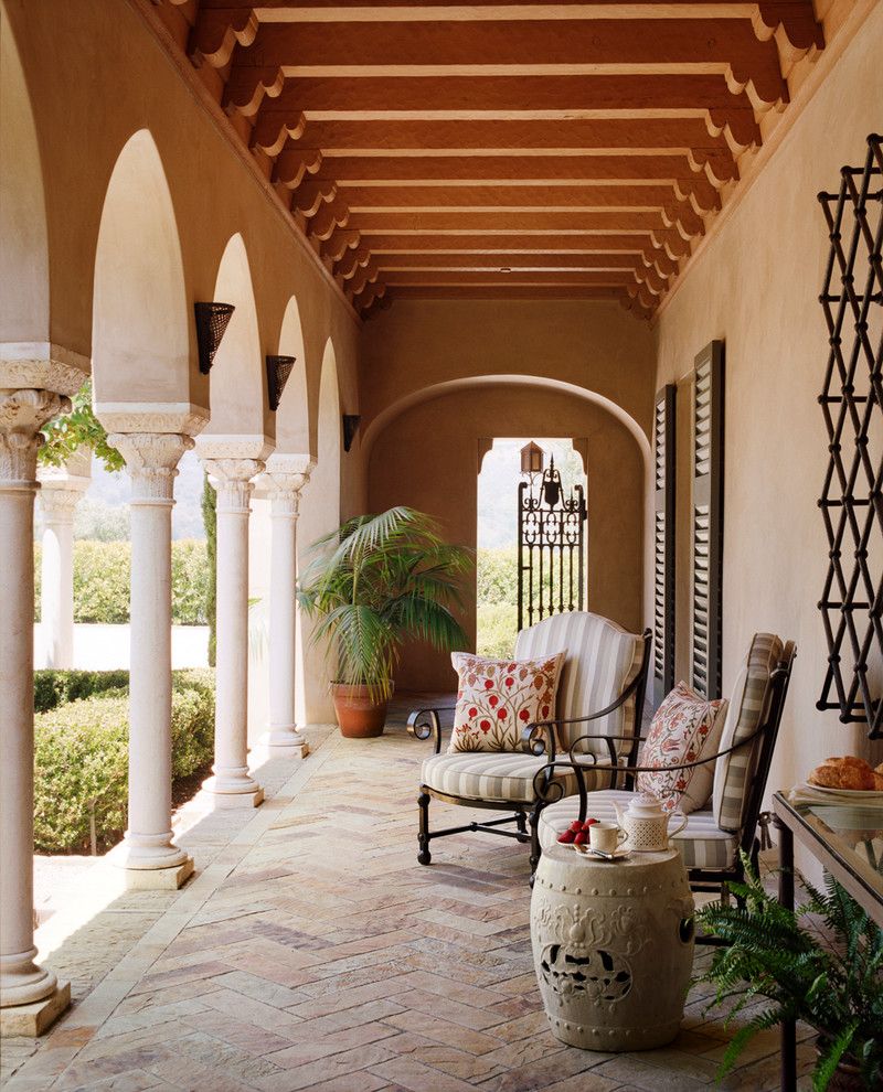 Corinthian Columns for a Mediterranean Porch with a Patio Chairs and Hilltop Villa by Tucker & Marks