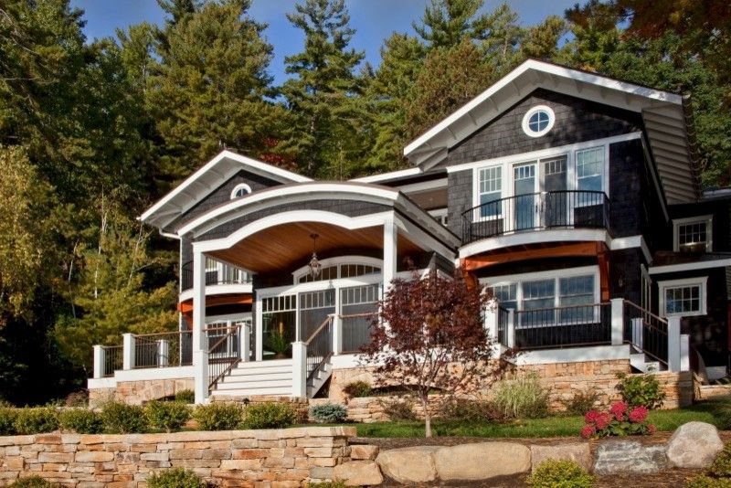 Corinthian Columns for a Traditional Exterior with a Cedar Shake Siding and Legend of the Lake by Teakwood Builders, Inc.