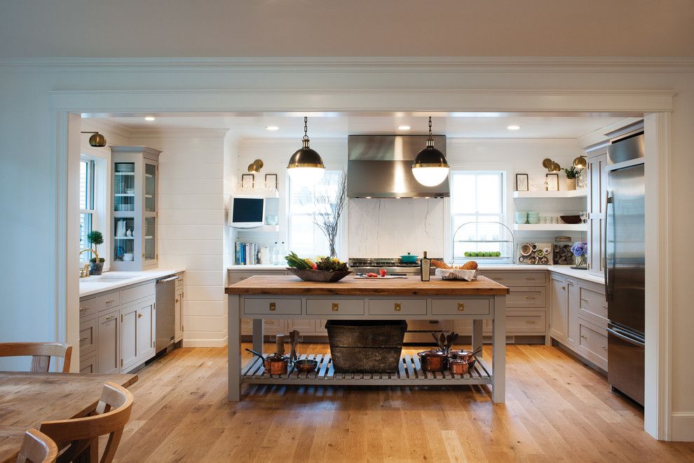 Crown Point Cabinetry for a Farmhouse Kitchen with a Unlaquered Brass Hardware and Farmhouse Kitchen with a Mid Century Twist by Crown Point Cabinetry