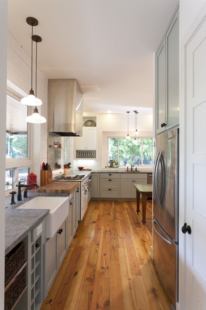 Cumtv for a Farmhouse Kitchen with a Stainless Steel Backsplash and Farmhouse Kitchen by Rauser Design