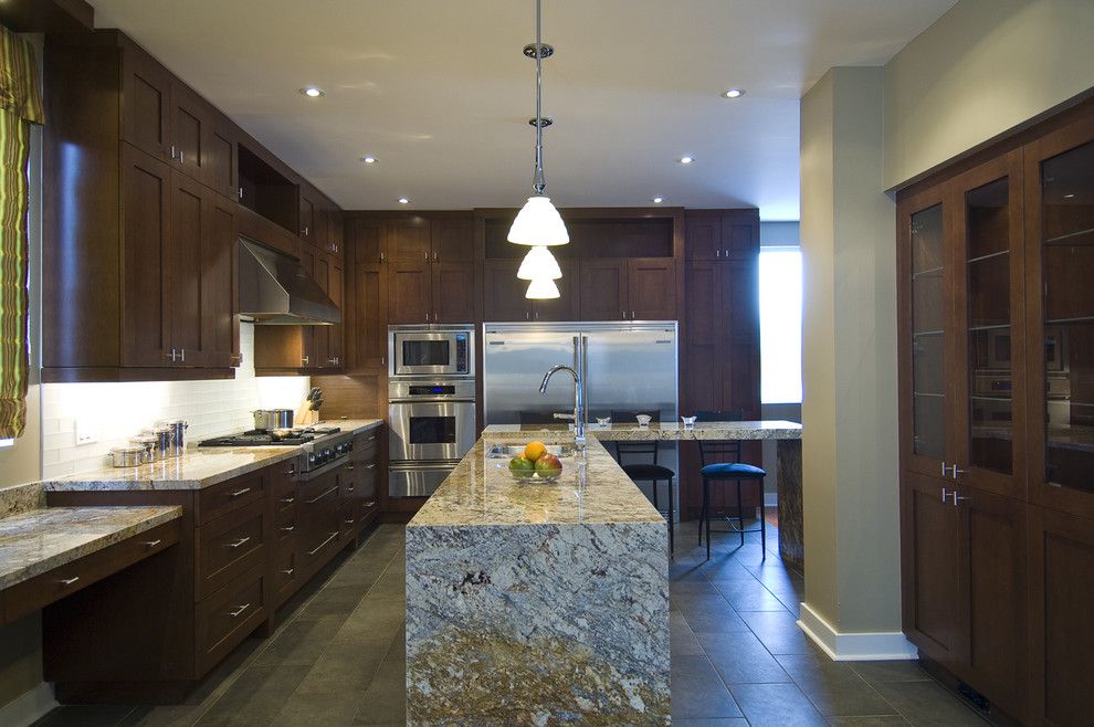 Delicatus Granite for a Contemporary Kitchen with a Pendant Lighting and a Chef's Dream by Biglarkinyan Design Planning Inc.