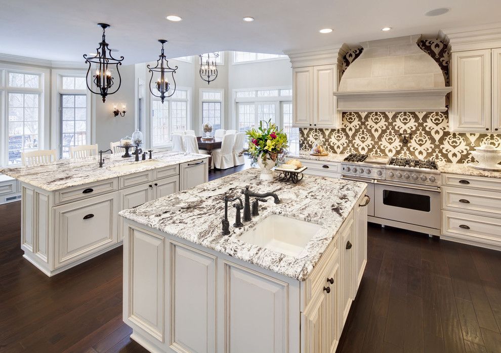 Delicatus Granite for a Traditional Kitchen with a White Kitchen and Kitchen by Kanncept Design, Inc.