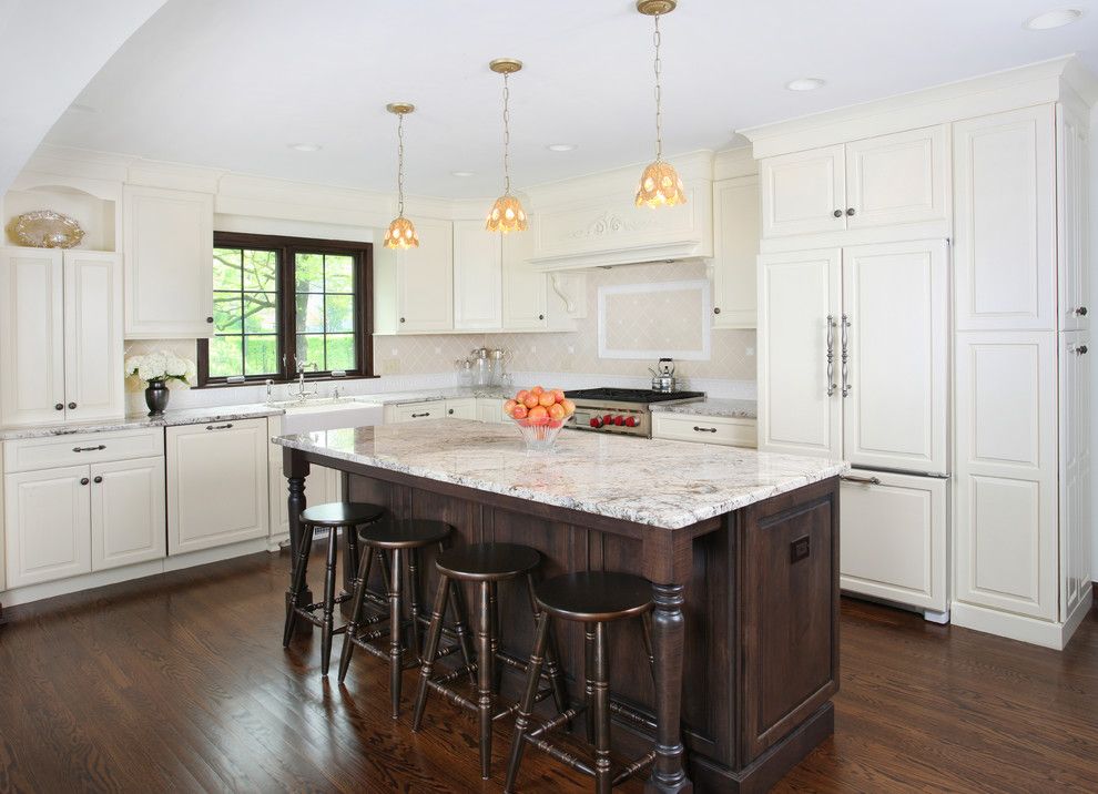 Delicatus White Granite for a Tropical Kitchen with a Stained Island and Vintage Kitchen in Tudor Style Home by Normandy Remodeling