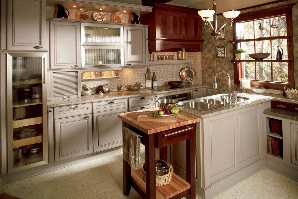 Discover Marble and Granite for a Traditional Kitchen with a Chandelier and Wellborn Cabinet by Wellborn Cabinet, Inc.