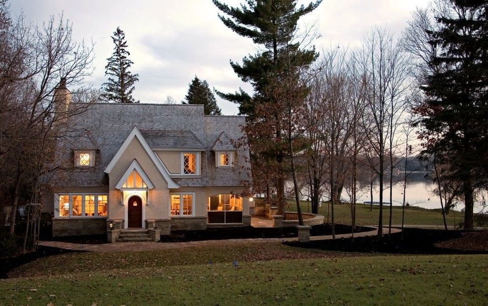 Dormer Windows for a Traditional Exterior with a Stone Chimney and Exterior by John Kraemer & Sons