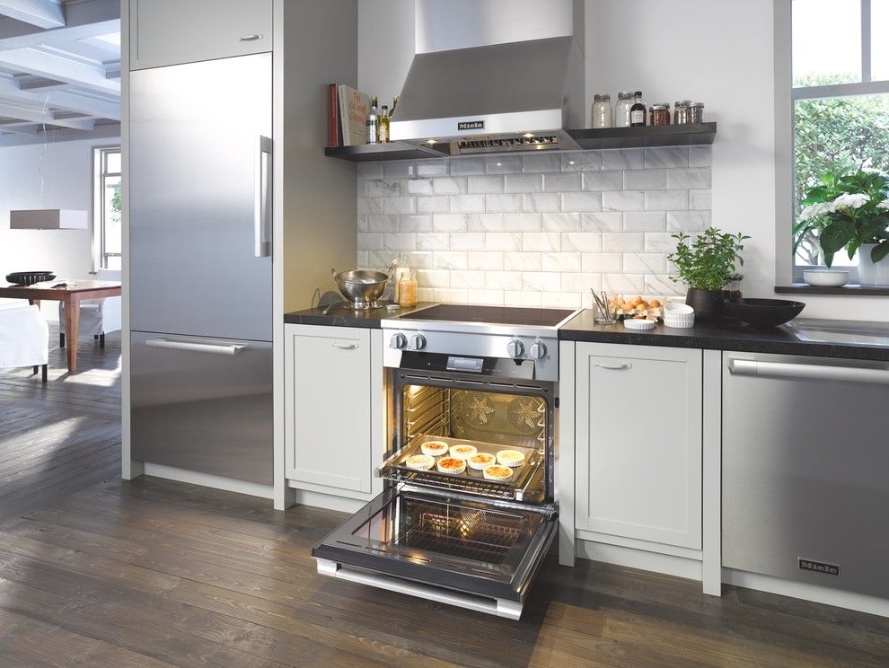 Dovetail Furniture for a Modern Kitchen with a Beveled Subway Tile and Miele by Miele Appliance Inc