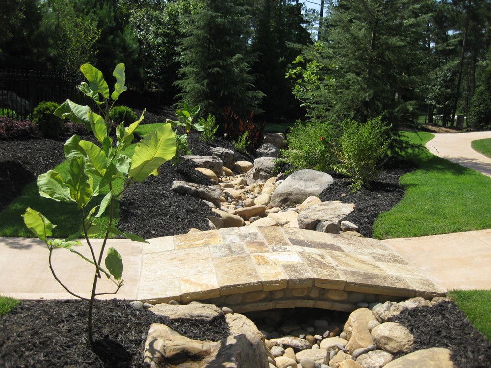 Drainage Ditch for a Mediterranean Landscape with a Stone Bridge and Cabana @ the Manor, Milton, Ga by Vesta Homes, Inc.