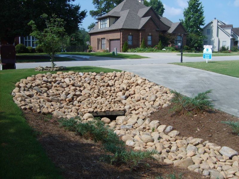 Drainage Ditch for a Traditional Landscape with a Dry Creek Bed and Drainage and Erosion Control by Alabama Landscape Creations