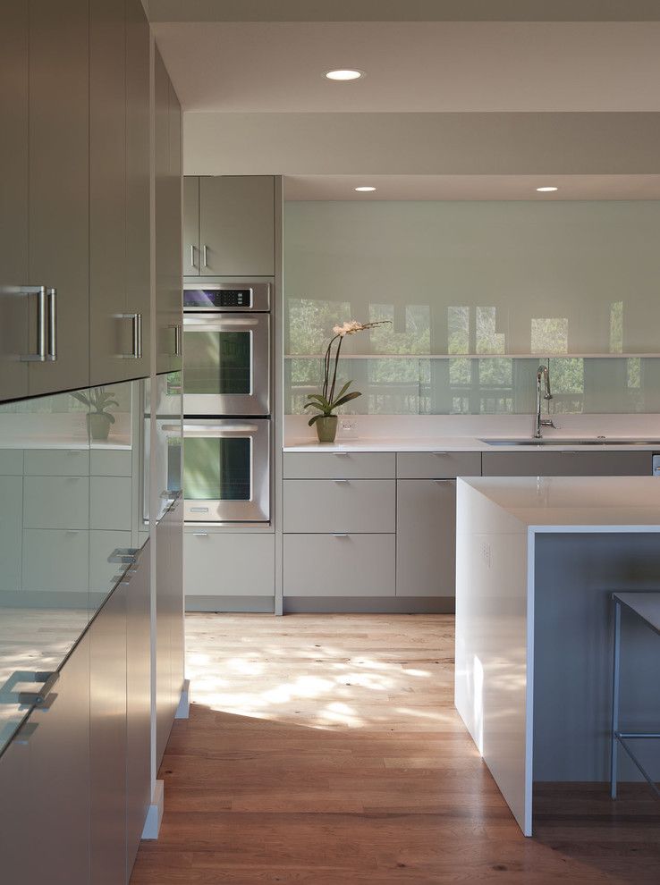 Engineered Hardwood vs Laminate for a Modern Kitchen with a Waterfall Counters and Foxtree Cove by Webber + Studio, Architects