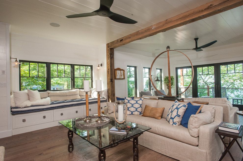 Engineered Hardwood vs Laminate for a Rustic Living Room with a Glass Coffee Table and Lake George Retreat by Phinney Design Group