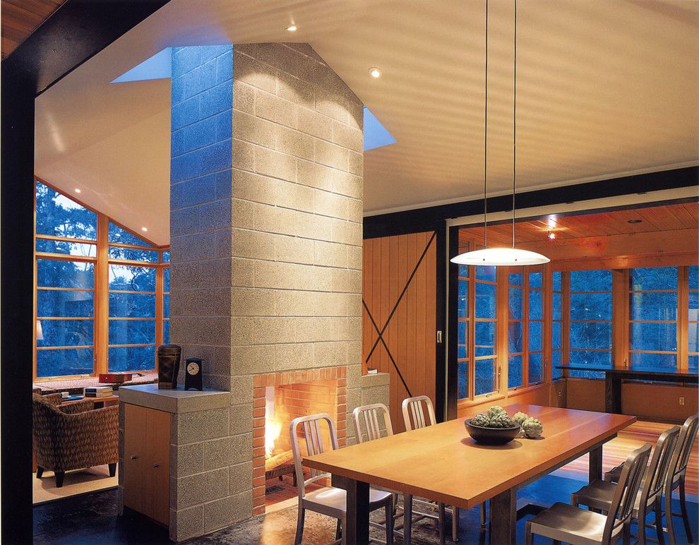 Eureka Lighting for a Rustic Dining Room with a Concrete Fireplace and Buchter Retreat by David Coleman / Architecture