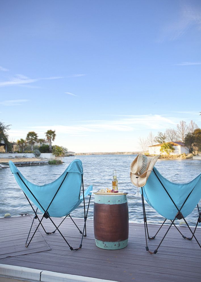 Fallingwater House for a Beach Style Deck with a Lakefront and Hill Country Lake House by Casey St. John Interiors