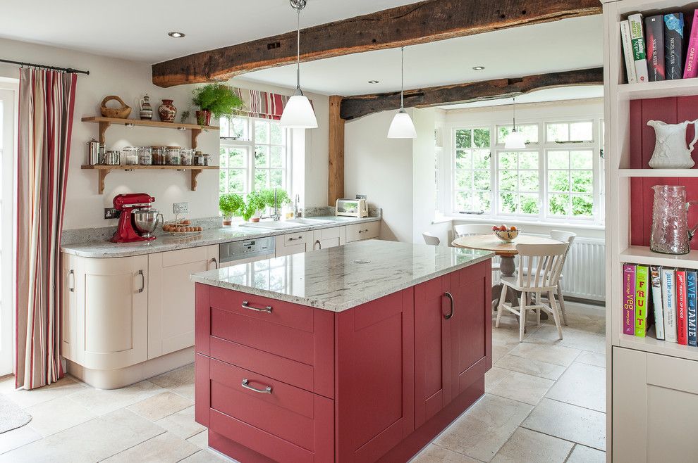 Freds Appliance for a Farmhouse Kitchen with a Round Dining Table and Cottage Kitchen Accented with Red by J M Interiors