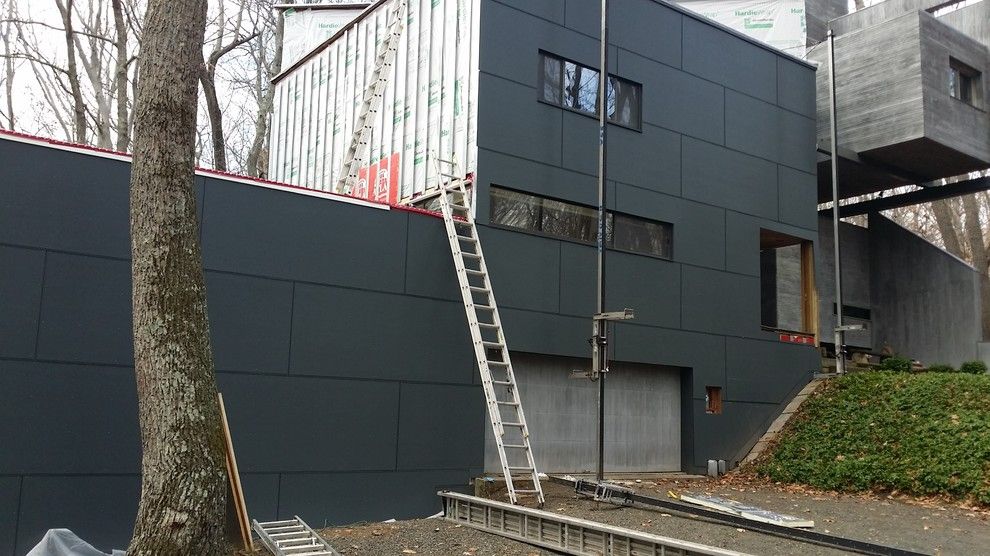 Fry Reglet for a Contemporary Exterior with a Fiber Cement and Iron Grey Hardiepanel W/ Fry Reglet Aluminum Trim by Burr Roofing Siding Windows