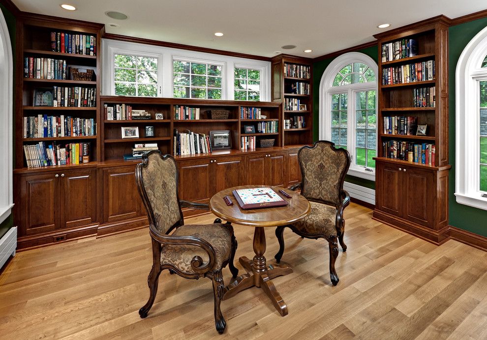 Gabberts Furniture for a Traditional Family Room with a Library and Gummy Cherry Library by Steven Cabinets