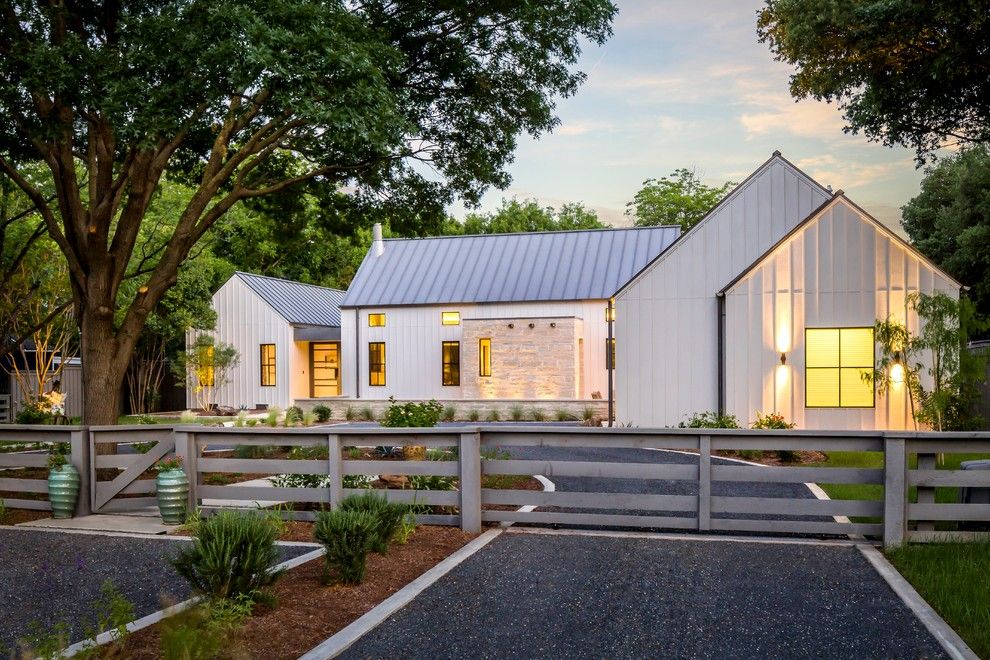 Gabled Roof for a Farmhouse Exterior with a Gravel Driveway and Modern Farmhouse in Dallas, Texas by Olsen Studios