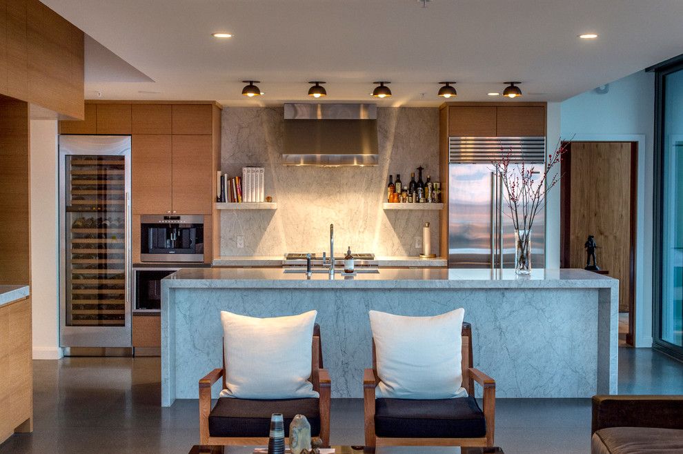 Galley Kitchens for a Contemporary Kitchen with a Waterfall Countertop and White Marble Waterfall Island by Huseby Homes