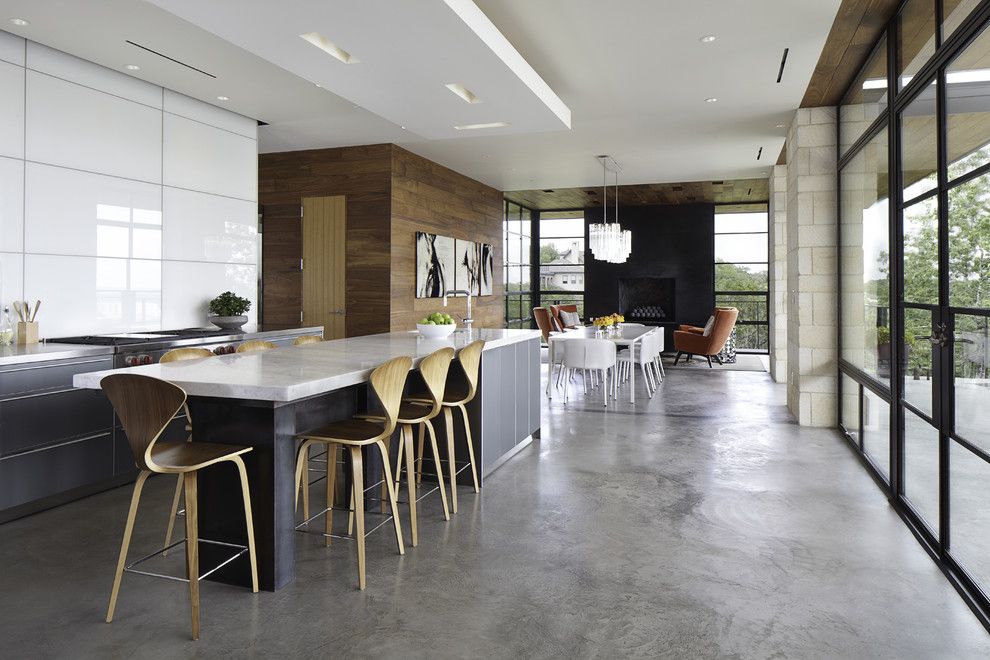 Galley Kitchens for a Modern Kitchen with a Black Fireplace and Hill Country Residence by Cornerstone Architects