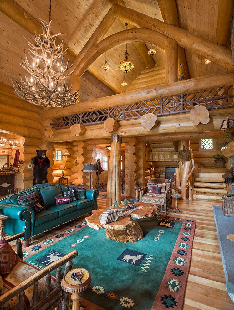 Gastineau Log Homes for a Rustic Living Room with a Chandelier and Big Moose, New York Log Home by Sitka Log Homes