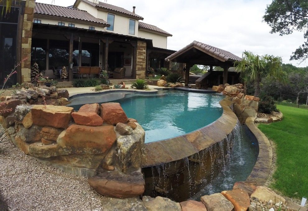 Gold Medal Pools for a  Pool with a Infinity and Vanishing Edge Pool with Swim Up Bar by Ocean Quest Pools by Lew Akins